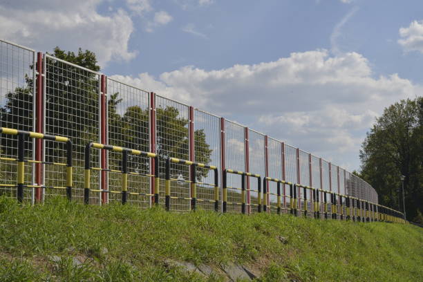 istock Protective fences in a public park, around the bicycle path 1076082772