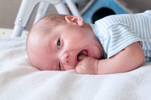 istock The baby cries and pulls the handle into his mouth because of the cutting teeth. Selective focus. 1076090204