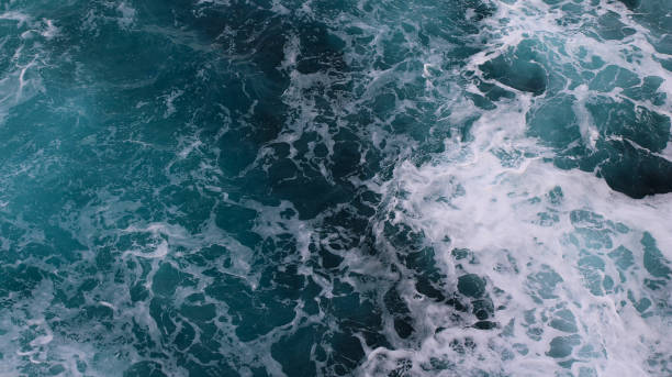 istock blue and white foamy ocean waves 1076090754