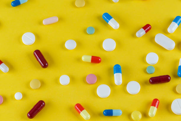 istock different pills and capsules scattered on a yellow background 1076091062