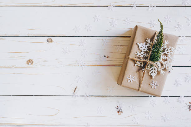 istock Brown gift box and Christmas presents on white wooden table background. 1076095116
