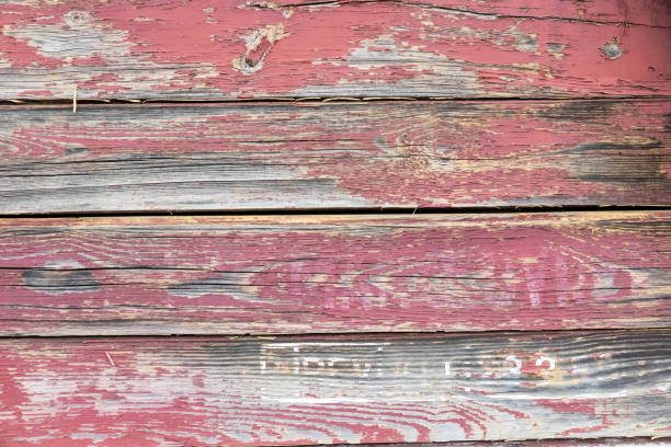 the wall of the train wagon is made of wood and the paint is peeling