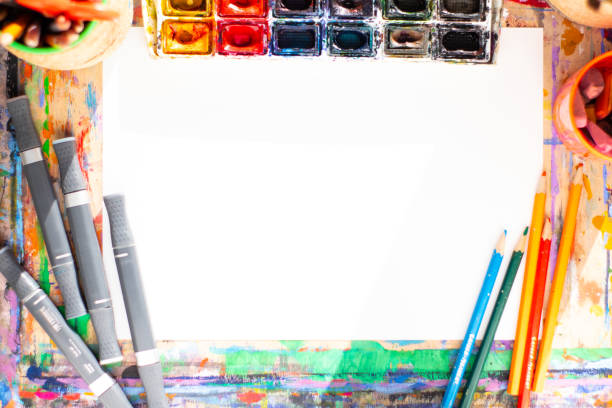 istock Drawing objects background. Highlights, paint, pencil and paper in center 1076096628
