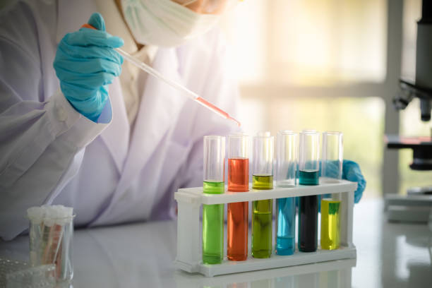 istock Scientist hold pipette adding fluid to test tubes or glassware 1076099036