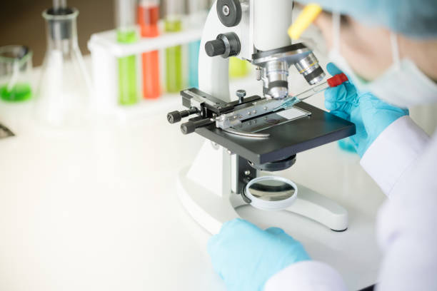 istock Scientist hold pipette adding fluid to test tubes or glassware 1076099072