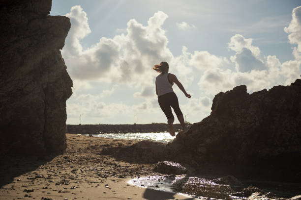 istock Silhouete female run at beach 1076100410