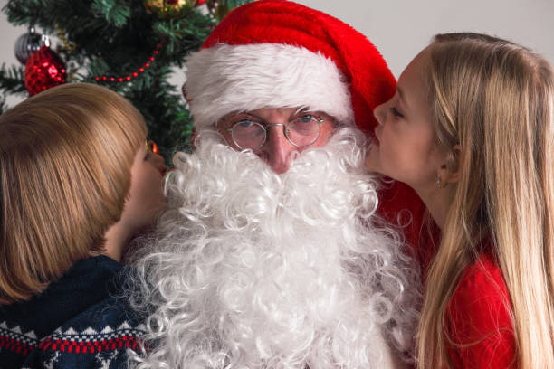istock Children whispering to Santa Claus 1076105612