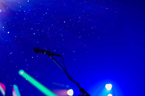 istock Show on stage with microphone on with bright background in celebration concept with copy space.... 1076109790