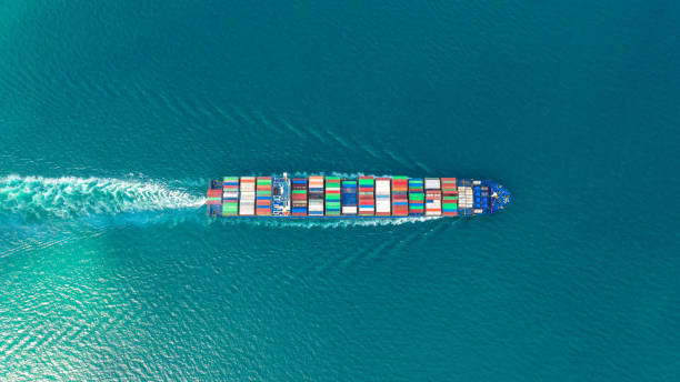 istock Container ship in export and import business and logistics. Shipping cargo to harbor by crane. Water transport International. Aerial view and top view. 1076111750