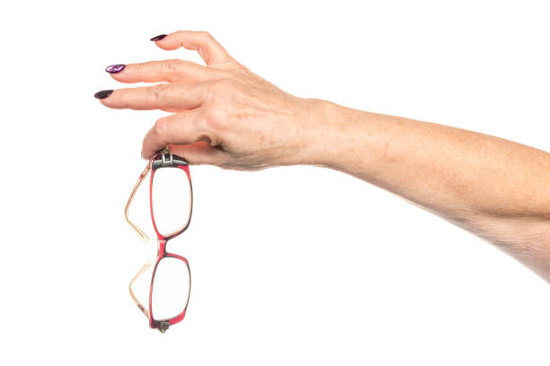 istock Old female hand holds glasses 1076113996