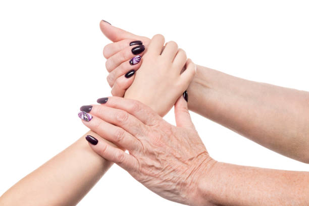 istock Female old hand holds a child palm 1076113998