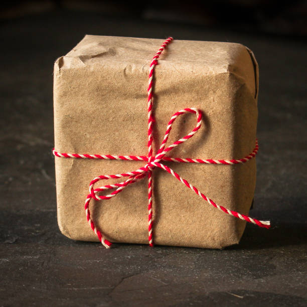 istock Gift Box with Ribbon - craft paper  (dark background). top view, copy space 1076114424