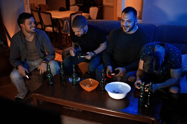 istock Friends playing video games and eating snacks 1076114794