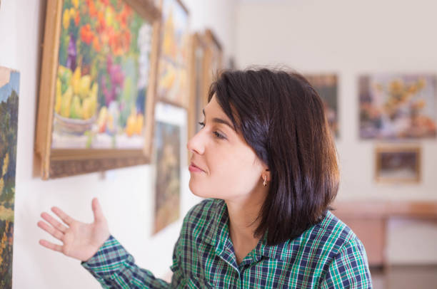 istock A young beautiful woman looking at painting. 1076120554
