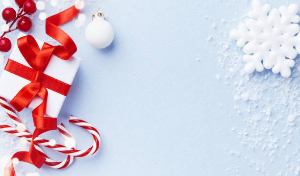 istock Christmas card or banner. Christmas gift box and decorations on blue background. 1076128908