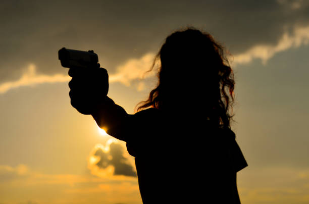 istock man in gun position with gun 1076135384