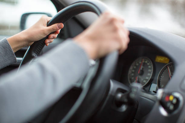istock Driver's hands driving a car on a highway 1076141564