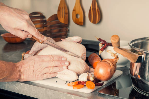 istock Male preparing chicken soup at home kitchen. Toned image 1076146120