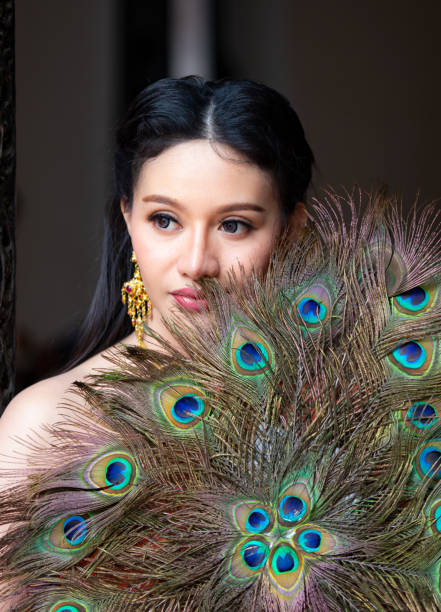 istock Beautiful Woman With Peacock Feathers 1076146400