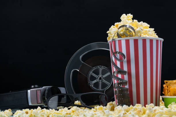 istock paper cups and film from an old video camera on popcorn 1076150080