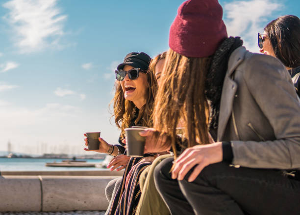 istock Happy friends laughing and drinking coffee to go 1076151414