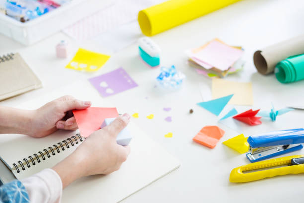 istock Cropped Hands Of Artist Holding Adhesive Note At Table 1076157730