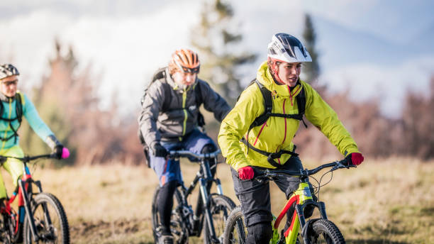 istock Front view of three friends mountain biking 1076160228