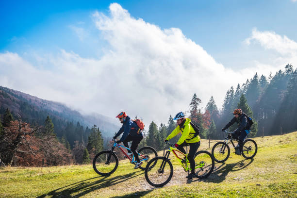 istock Side view of three friends mountain biking 1076160234