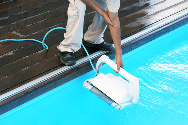 istock Hotel staff worker cleaning the pool. Maintenance. Automatic pool cleaners. 1076166656