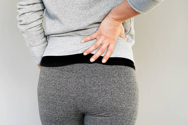 istock Woman, pain at lower back. 1076171082