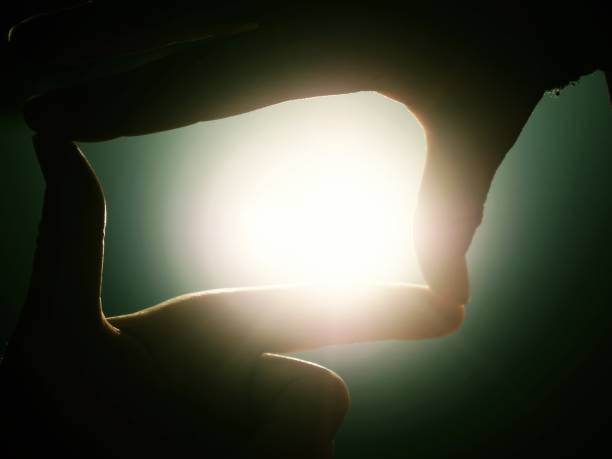 istock Hands stretch toward the sun on lake level. 1076176882