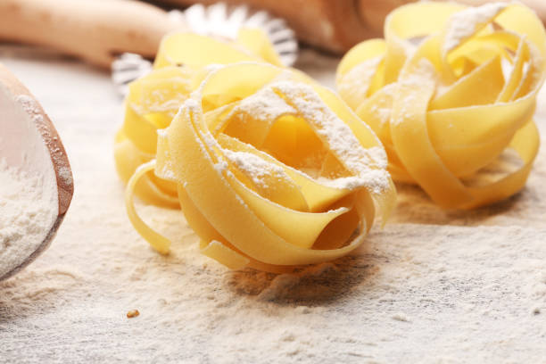 istock pasta. Fresh homemade pasta with pasta ingredients on the rustic table. 1076177194