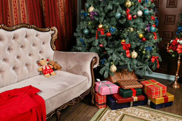 istock Presents and Gift boxes under Christmas Tree. Colorful boxes with ribbon bow. New year decorated house interior. Winter Holiday concept. 1076177712