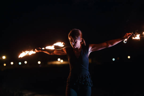 istock Confident circus girl spinning fire 1076190758