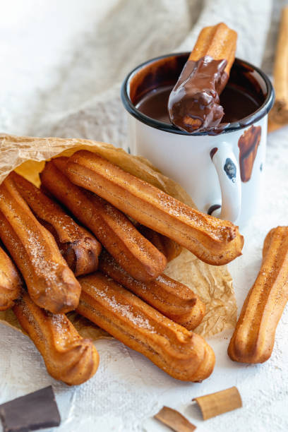 istock Traditional spanish churros dessert with hot chocolate. 1076200480