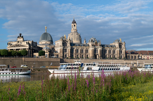 Dresden, Germany - June 19, 2018. Tour boats on the Elbe River with the Old Town of Dresden in background, Saxony, Germany