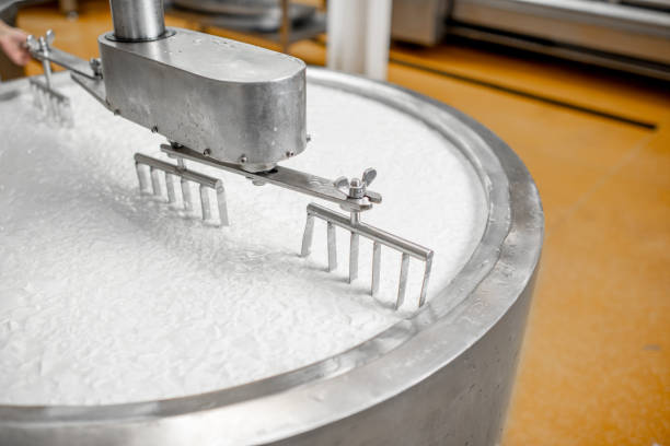 istock Milk mixing at the cheese manufacturing 1076205068