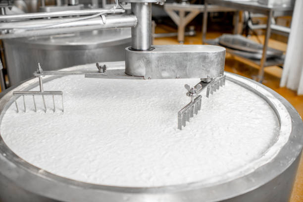 istock Milk mixing at the cheese manufacturing 1076205072