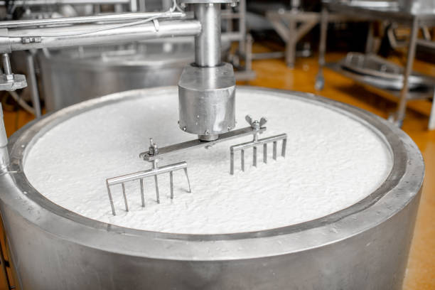 istock Milk mixing at the cheese manufacturing 1076205084