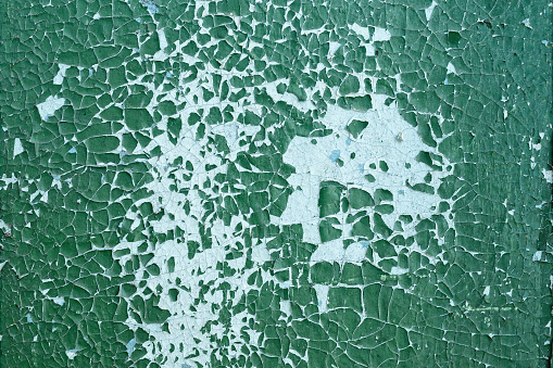 Old green paint on the wall with blue background