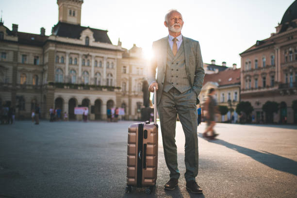istock Handsome looking senior businessman on a town square 1076206188