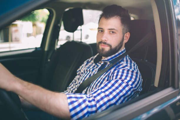 istock Handsome elegant serious man drives a car. 1076211992