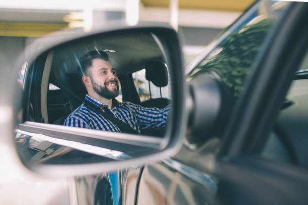 istock Handsome elegant serious man drives a car. 1076211994
