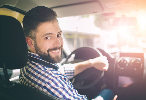 istock Handsome elegant serious man drives a car 1076212014