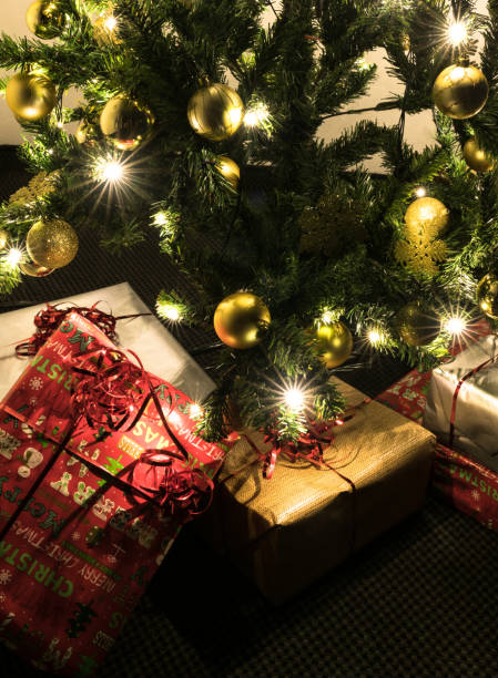 istock colorful presents under a beautifully decorated Christmas tree with baubles and lights 1076233986