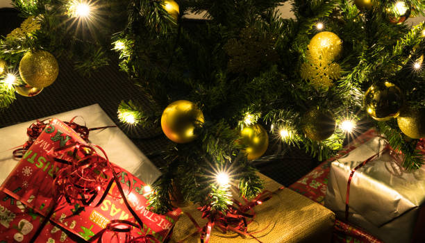 istock colorful presents under a beautifully decorated Christmas tree with baubles and lights 1076234430