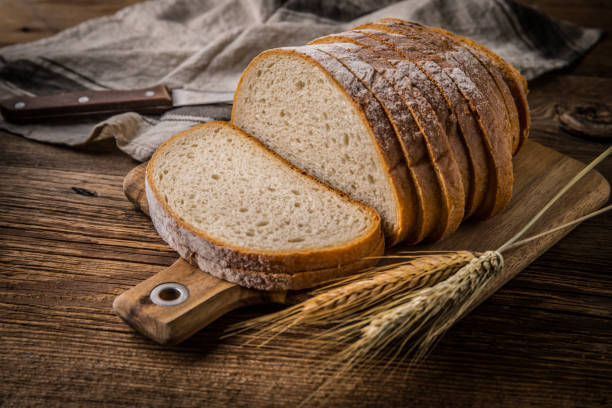 istock Sliced loaf of bread on a chopping board. 1076238910