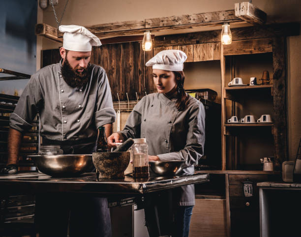 istock Chef teaching his assistant to bake the bread in the bakery. 1076244900
