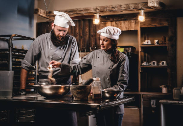 istock Cook assistant pours sesame into a bowl. 1076247362