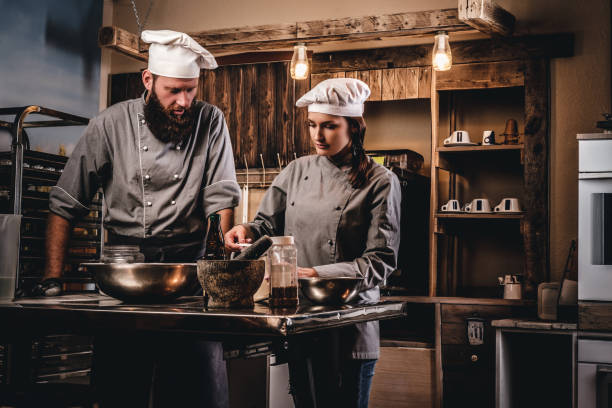 istock Chef teaching his assistant to bake the bread in the bakery. 1076249034